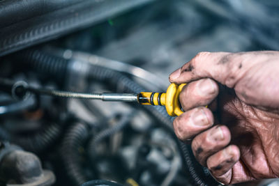 Close-up of mechanic repairing car