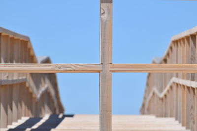 Low angle view of metallic structure against clear blue sky