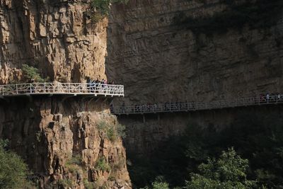 Bridge over river amidst cliff