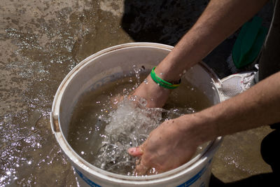 High angle view of hands over water