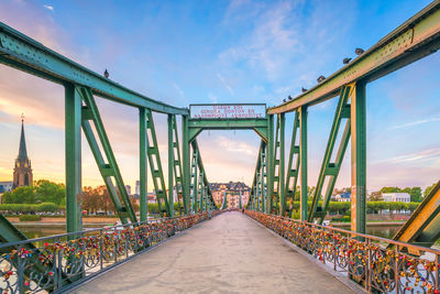 Bridge over road against sky in city