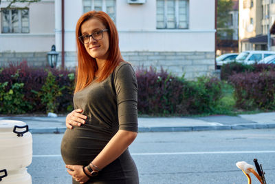 Portrait of smiling young woman standing outdoors