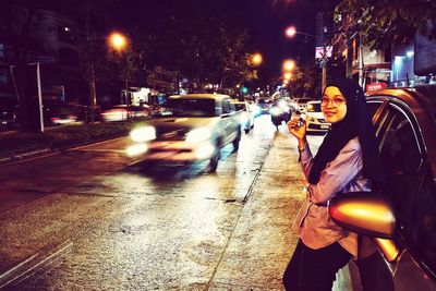 Cars on city street at night