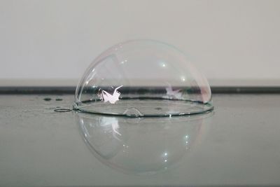 Close-up of water on table against white background