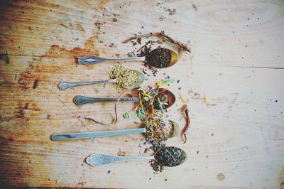 Directly above view of herbs in spoons on table