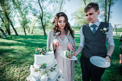 Couple cutting cake during wedding ceremony