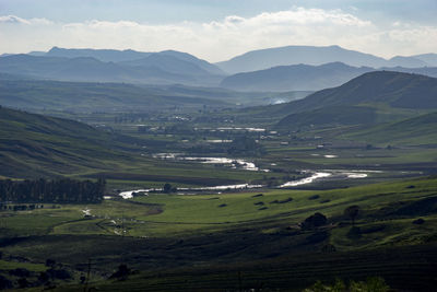 Scenic view of landscape and mountains against sky