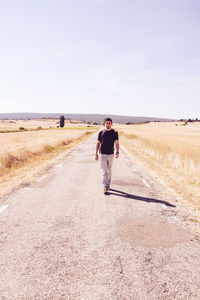 Full length of man walking on road