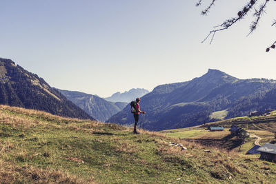 Man standing on mountain road against sky