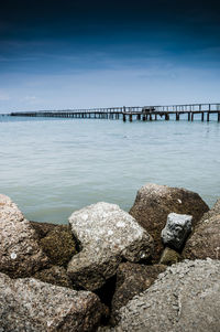 Tranquil view of pier at sea against sky