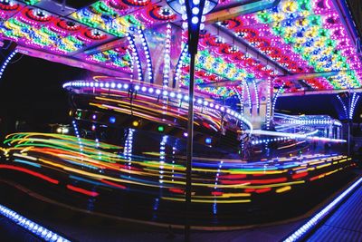 Light trails in amusement park at night