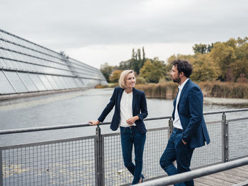 Female entrepreneur discussing with colleague while standing at office park