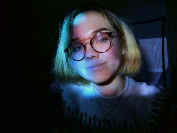 Close-up portrait of girl in darkroom