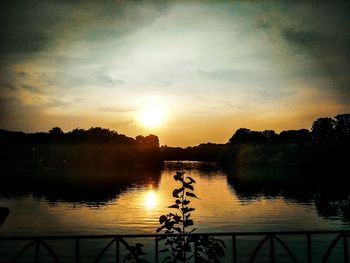 Scenic view of lake against sky during sunset