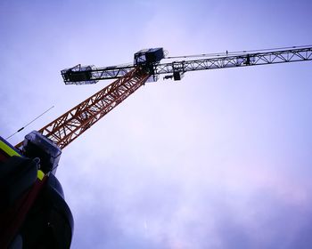 Low angle view of crane against sky