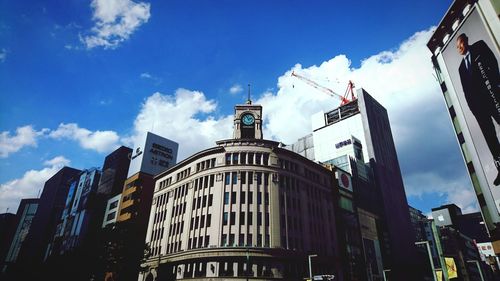 Low angle view of building against cloudy sky