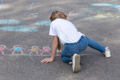 Rear view of girl on road