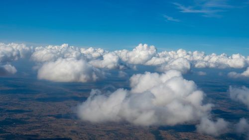 Aerial view of volcanic landscape against blue sky