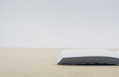 Close-up of book on table against white background