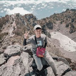 Portrait of man standing on rock