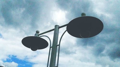 Low angle view of street light against cloudy sky