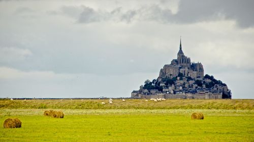 View of castle on landscape against sky