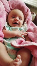 High angle view of cute happy baby girl lying at home