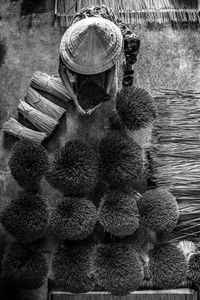 High angle view of woman holding sticks while sitting on land 