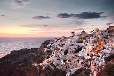 High angle view of townscape by sea against sky