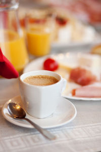 Coffee cup and cake on table