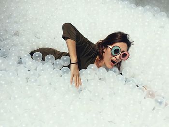 High angle view of woman playing in ball pool