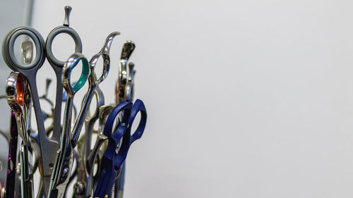 Close-up of metallic grooming equipment against white background