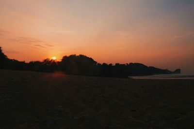 Scenic view of beach against sky during sunset