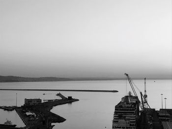 Commercial dock by sea against sky