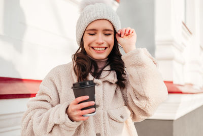 Smiling woman holding coffee cup