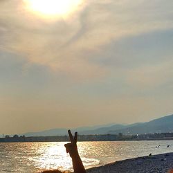 Scenic view of lake in front of mountains against sky during sunset