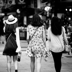 Rear view of women walking on street