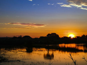 Scenic view of lake against sky during sunset