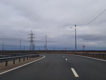 Road by bridge against sky in city