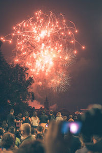 Low angle view of firework display at night