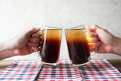 Midsection of man holding beer glass