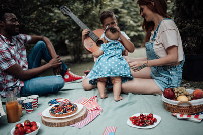 High angle view of people sitting on cutting board