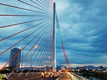 View of suspension bridge against cloudy sky