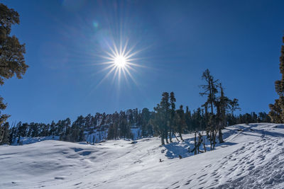 Scenic view of snow covered land against sky