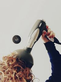 Low angle view of woman holding balloon