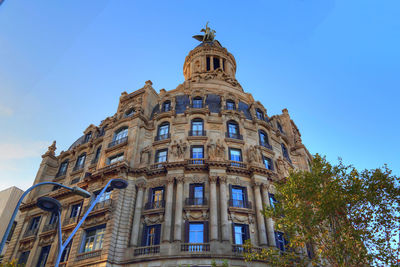 Low angle view of building against blue sky