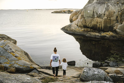 Mother walking with daughter at sea