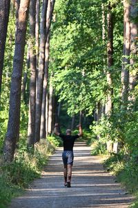 Rear view of woman walking in forest