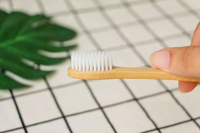 Close-up of person holding bamboo toothbrush