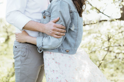 Midsection of couple holding hands